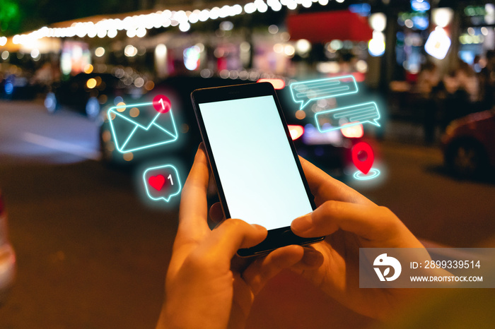 Young woman using smartphone with social media notification icons