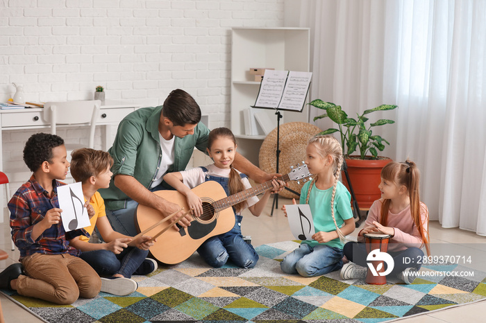 Teacher giving music lessons at school