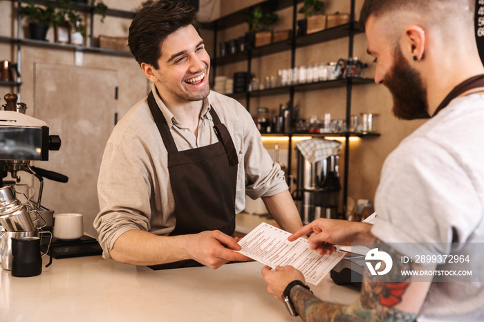 Close up of a customer paying at the coffee shop counter