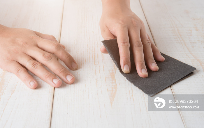 Sanding and smoothing wood with black sandpaper