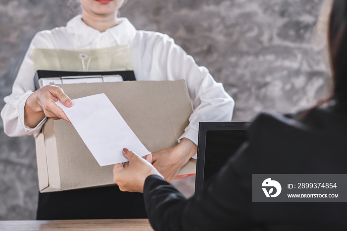 female worker hand giving resignation latter to boss quitting a job