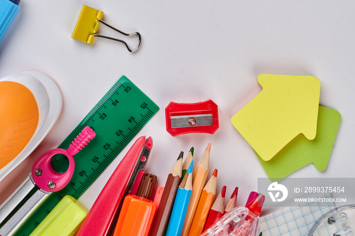 Various stationery school and office supplies. Colored pencils with school supplies on white backgro