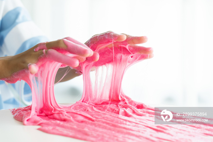 Hand Holding Homemade Toy Called Slime, Kids having fun and being creative by science experiment