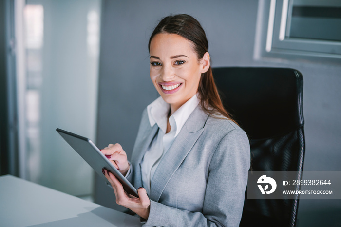 Portrait of a businesswoman working on tablet at modern office.