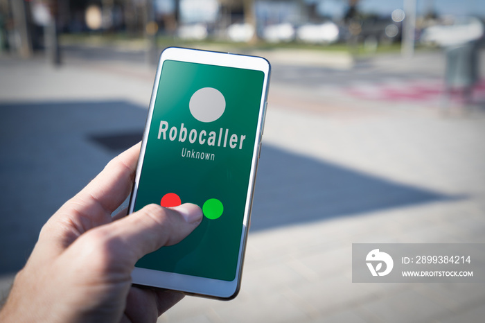 Smartphone showing on screen an illegal robocall. Smartphone showing a call from a robocaller on scr