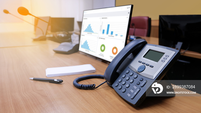 IP telephone on working table in meeting room for communication in office center.