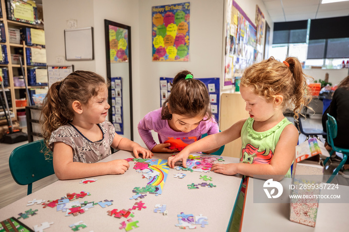 Girls working on puzzle