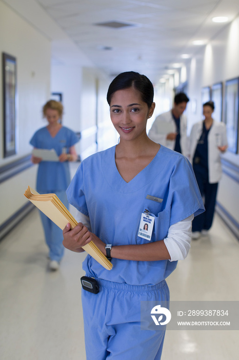 Portrait confident female nurse in hospital corridor