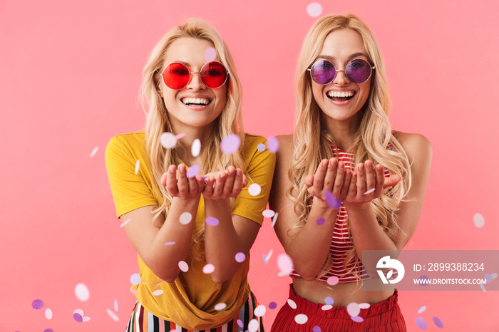 Happy pretty blonde twins in sunglasses having fun together