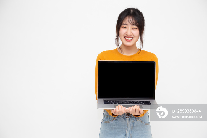 Young Asian woman showing a laptop computer over white background with copy space for presenting app