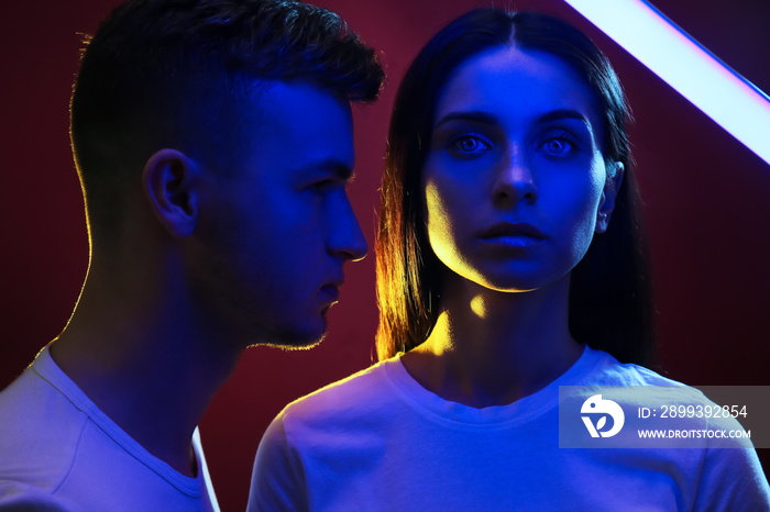 Toned portrait of young couple on dark background