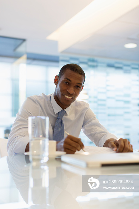 Portrait smiling businessman working in office