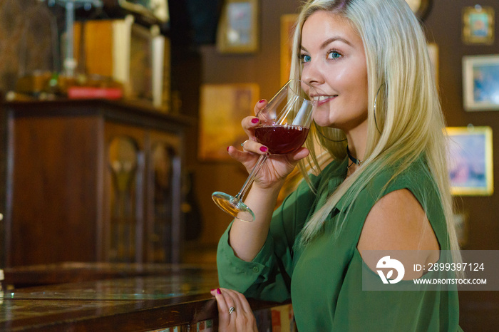 Girl with alcohol glass in pub club