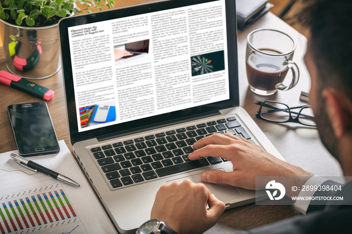 Man reading news on a laptop