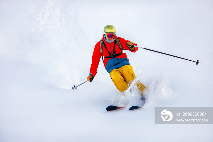 Man skier high speed rides on fresh snow, dust in air. Concept extreme winter sport