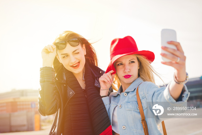 Young women taking selfie on street