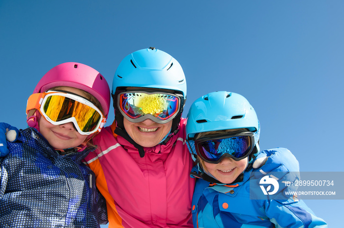 Happy family enjoying winter vacations in mountains . Ski, Sun,Snow and Fun