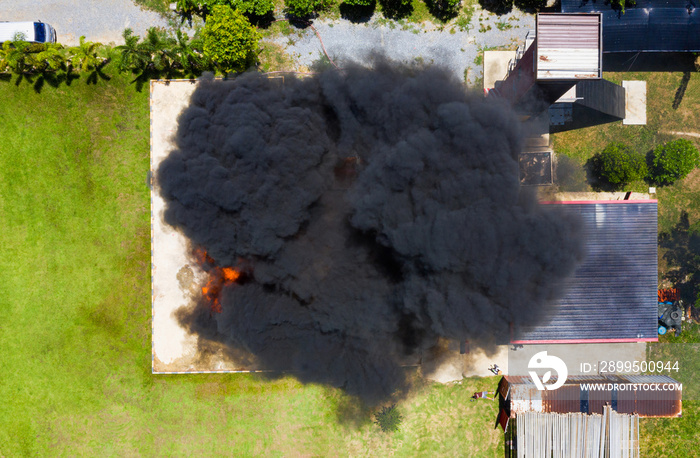 Aerial top view Fire and Firefighter training school. Three Fireman water spray by high pressure nozzle in fire fighting operation with copy space.