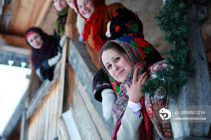 young girls in traditional costumes of the Russian north in winter