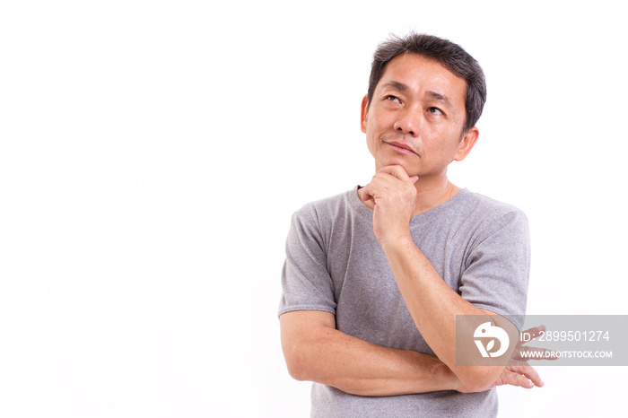 middle aged asian man thinking, studio isolated portrait