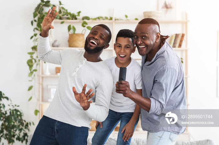 Joyful African Dad, Son And Grandfather Having Fun At Home, Singing Together