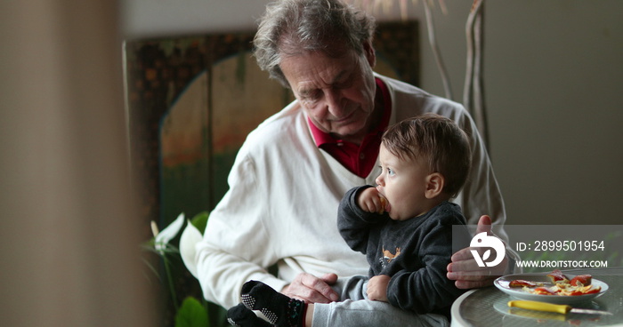 Casual candid grand-father with grandson baby at balcony