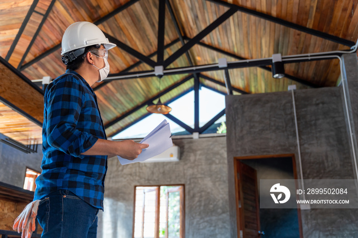 Construction engineer technician inspect the structure under the roof at construction site or building site of a house.