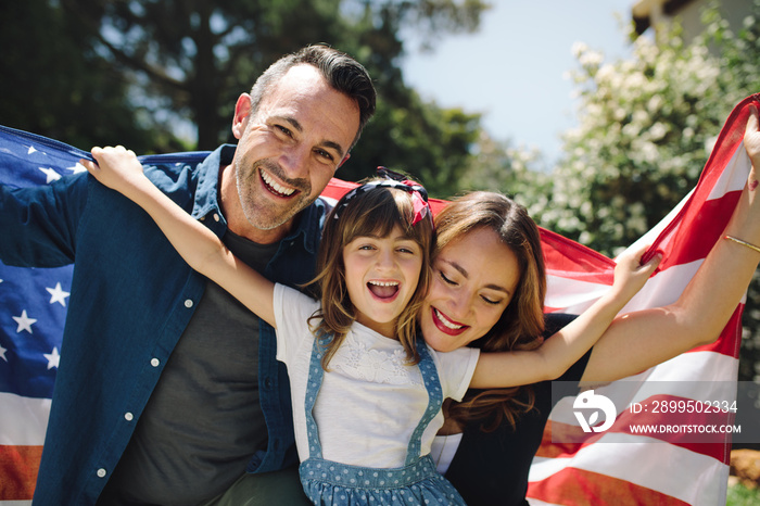 Close up of a happy family holding the american flag