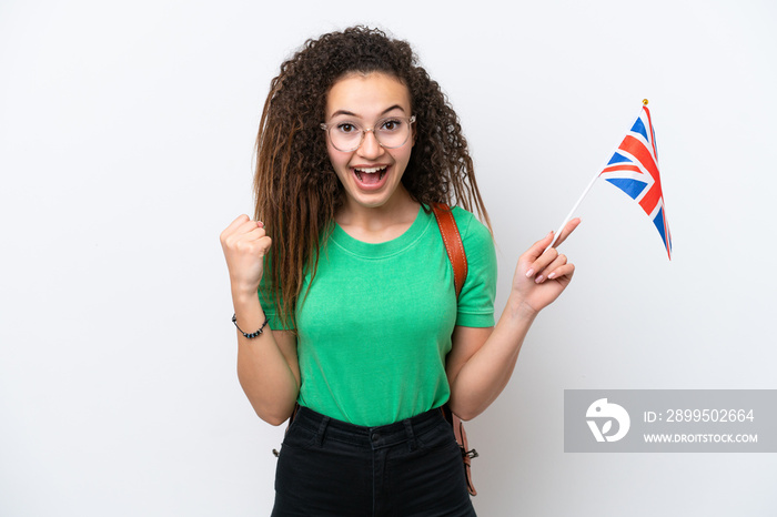 Young Arab woman holding an United Kingdom flag isolated on white background celebrating a victory in winner position