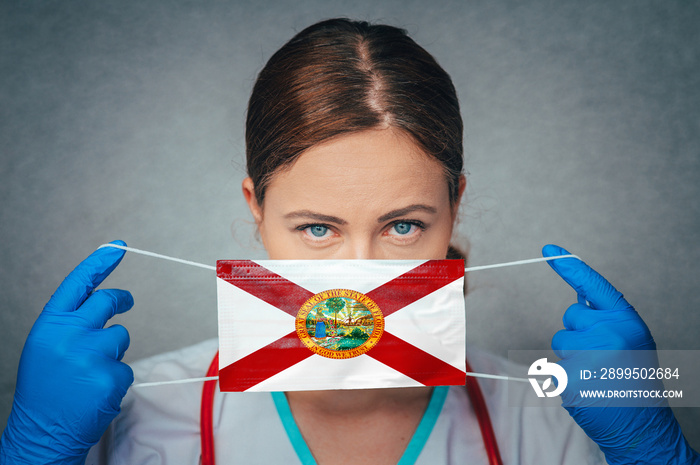 Coronavirus in U.S. State Florida, Female Doctor Portrait, protect Face surgical medical mask with Florida Flag. Illness, Virus Covid-19 in Florida