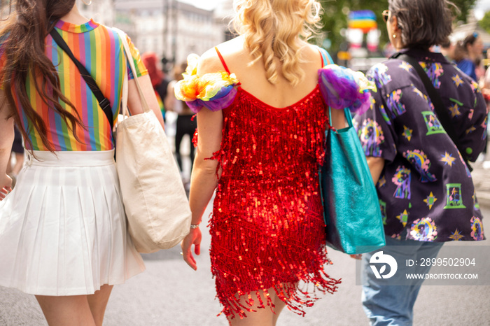 Women dressed in multi-colored clothes walking in street