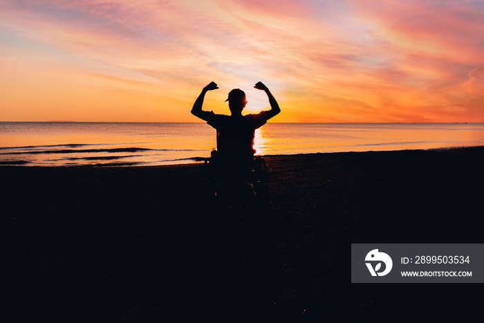 Behind of people with disability looking sunset on the sea beach at summer, Positive photos give life energy and power concept.