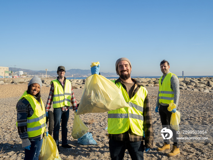 Group of young ecologist volunteers collecting garbage