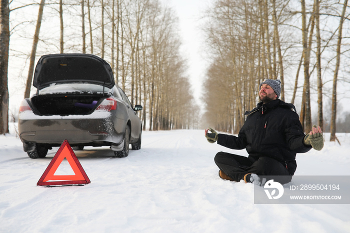 Man and car. Winter walk and car repair.