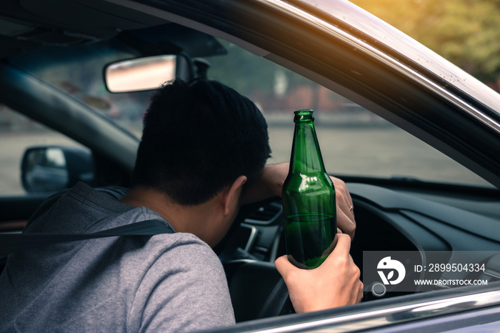 Asian men drink a lot of alcohol until and unconscious his can’t drive home and decide to sleep at the steering wheel.