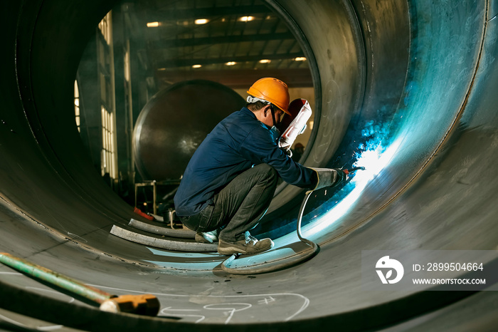 Asian workers are welding steel in a tunnel