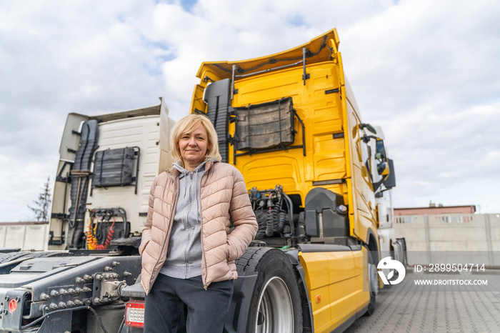 Caucasian mid age woman driving truck. trucker female worker, transport industry occupation