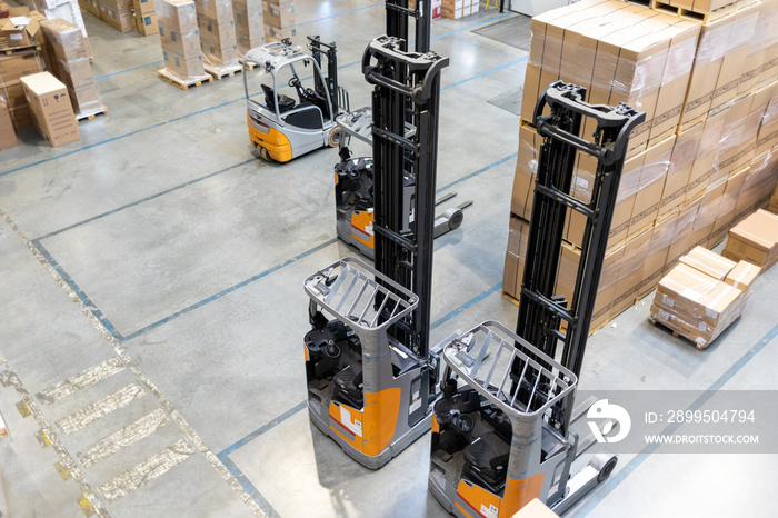 Forklifts parked in a warehouse alley