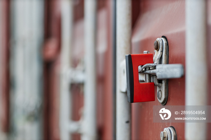 Close up of metal lock on door of cargo container in shipping docks, copy space