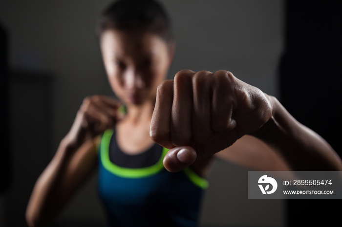 Woman practicing boxing in fitness studio