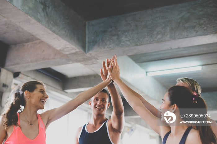 Hand coordination of group people smiling with motivated,Sporty young friendly team attractive and holding or raise up hands together