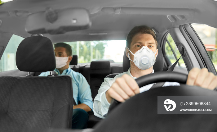 health care, safety and pandemic concept - male taxi driver driving car and passenger wearing face protective mask for protection from virus disease