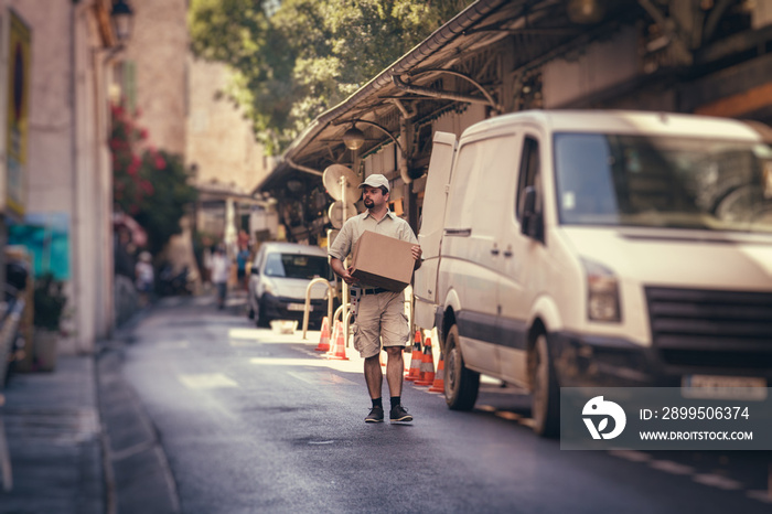 Messenger Delivering Parcel, Walking In Street Next To His Van