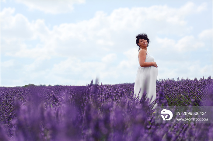 Smiling pregnant woman on lavender field