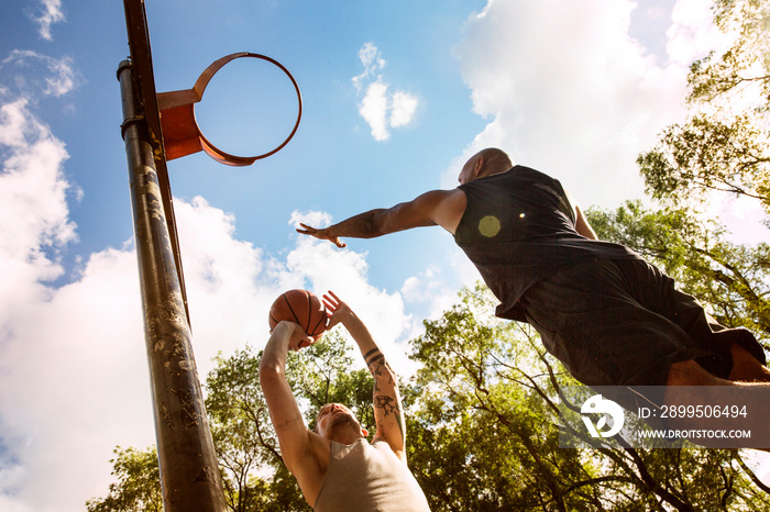 Low angle view of men playing basketball