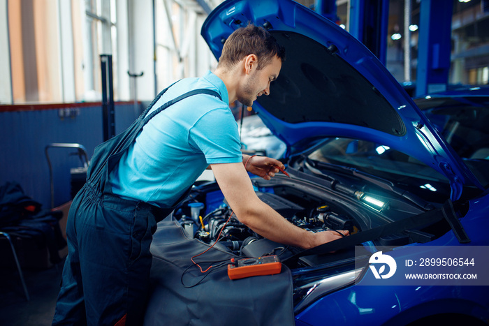 Auto electrician checks electrical circuits