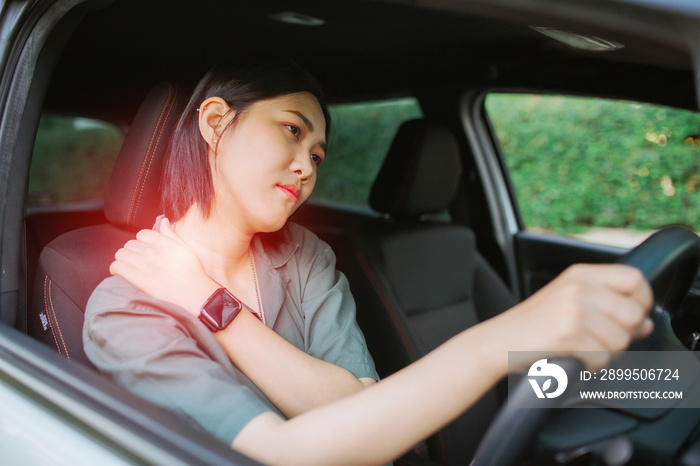 Beautiful Asian woman having pain in arm and shoulder Beautiful Asian woman massaging her arm or shoulder long driving on the way