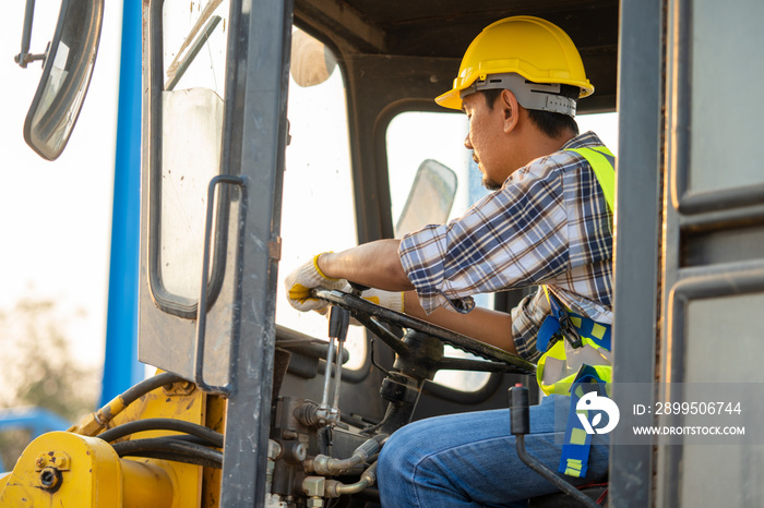 Construction driver driving backhoe loader at construction building site,Business and construction concept.