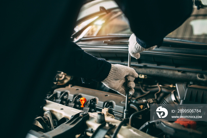 Car Repair service, Auto mechanic working in garage, Mechanic hands checking up of serviceability of the car in open hood, close up