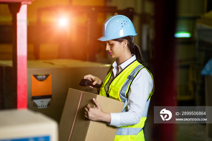 Young latina woman working in the warehouse.